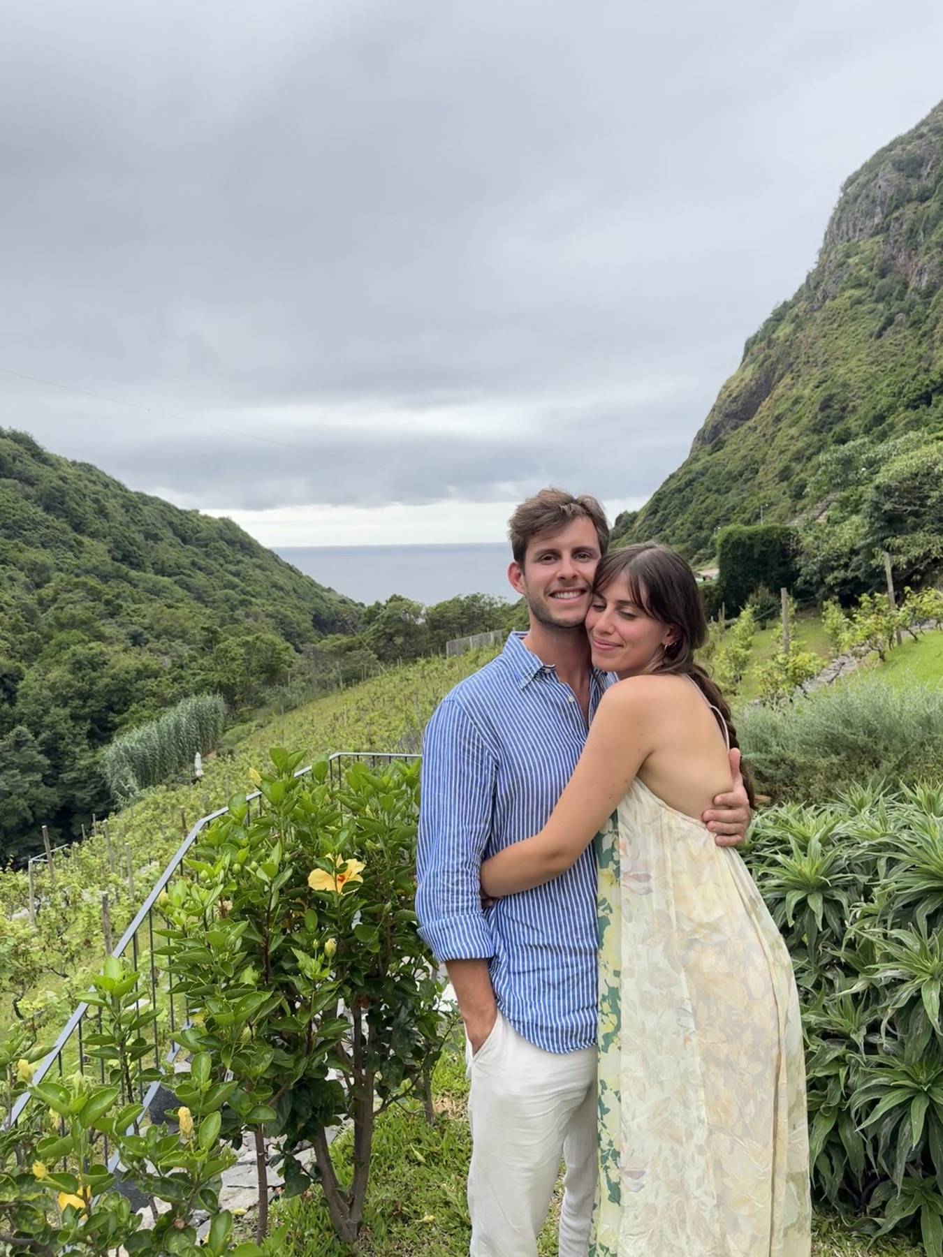 Giuliana and Arthur embracing in a hillside garden